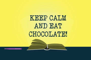 Conceptual hand writing showing Keep Calm And Eat Chocolate. Business photo showcasing Everything is better when you are eating sweets Color Pages of Book on Table with Pen and Light Beam Glaring