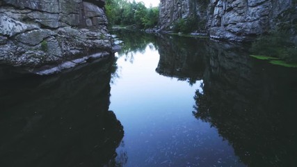 Mountain rivulet running between rocks with cracks in the Carpathians in summer