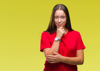 Young beautiful caucasian woman over isolated background looking confident at the camera with smile with crossed arms and hand raised on chin. Thinking positive.