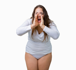 Fototapeta premium Beautiful plus size young overwight woman wearing white underwear over isolated background shouting and screaming loud to side with hand on mouth. Communication concept.