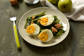 hard-boiled eggs with spinach salad, green beans and walnuts