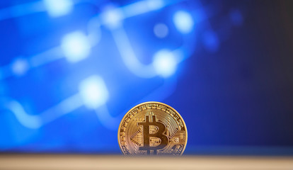 bitcoin on blue chart background - cryptocurrency concept