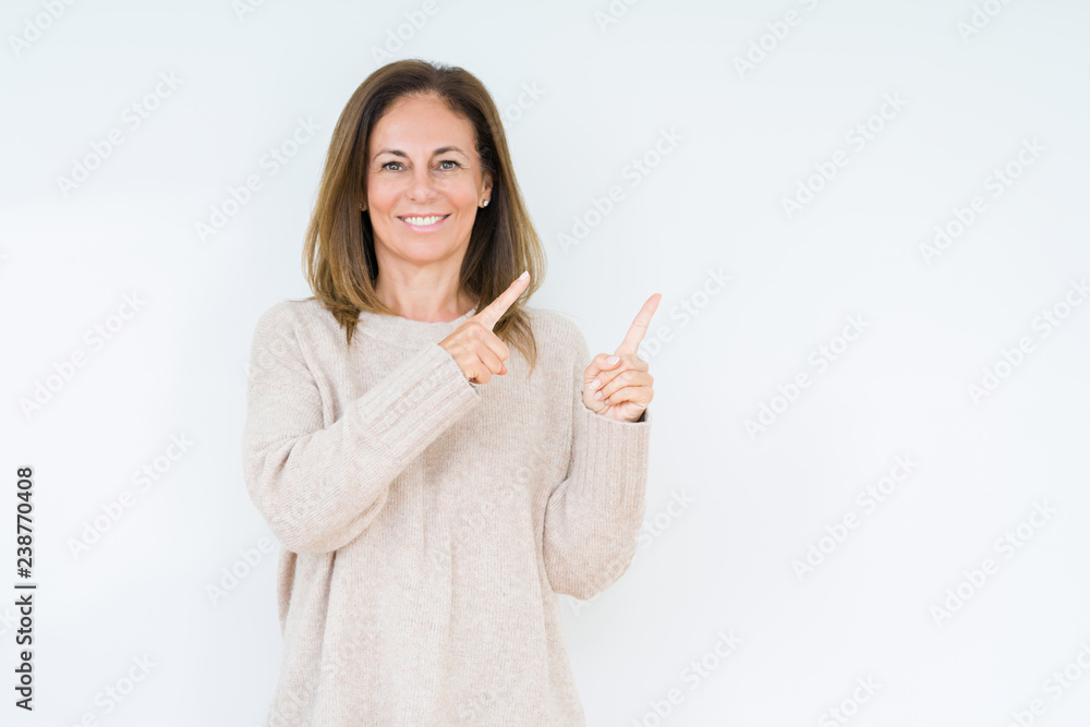 Wall mural beautiful middle age woman over isolated background smiling and looking at the camera pointing with 