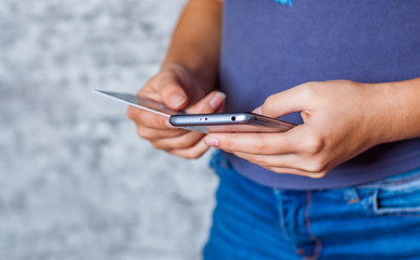 Close-up woman's hands holding a credit card and using smartphone for online shopping