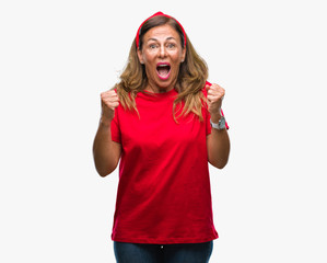 Fototapeta na wymiar Middle age senior hispanic woman over isolated background celebrating surprised and amazed for success with arms raised and open eyes. Winner concept.