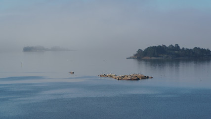 Islands in Baltic sea in mist. Foggy landscape.