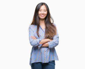 Obraz premium Young asian woman over isolated background happy face smiling with crossed arms looking at the camera. Positive person.