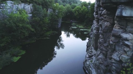Mountain pool surrounded with lofty rocks in the Carpathian Mountains in summer