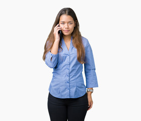 Fototapeta premium Young beautiful brunette business woman talking on smartphone over isolated background with a confident expression on smart face thinking serious