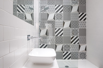 Contemporary loft bathroom with walk in shower unit and black and white monochrome porcelain wall tiles.
