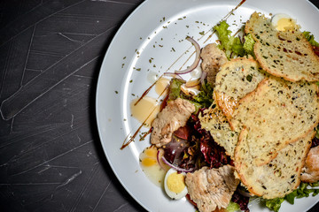 Fresh salad in plate on wooden table