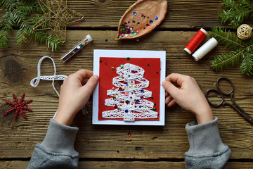 Making of handmade christmas greeting card from felt with your own hands. Children's DIY concept. Making xmas decoration