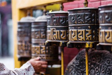 Prayer wheels at Boudhanath Stupa in Kathmandu, Nepal - obrazy, fototapety, plakaty