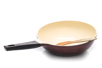 New wok with wooden spatula isolated on white background. Chinese frying pan.