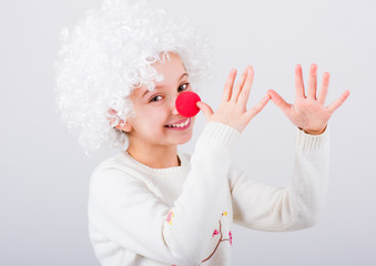 Pretty teen girl in white clown wig and red nose gesturing with hands