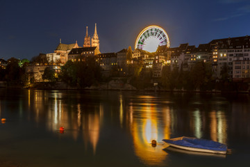 Basel city view with munster and ferris wheel at night