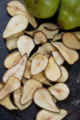 Crispy fruit chips made of pear, vertical shot, close-up