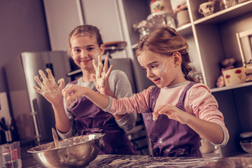 Nice smart girl standing in front of the bowl