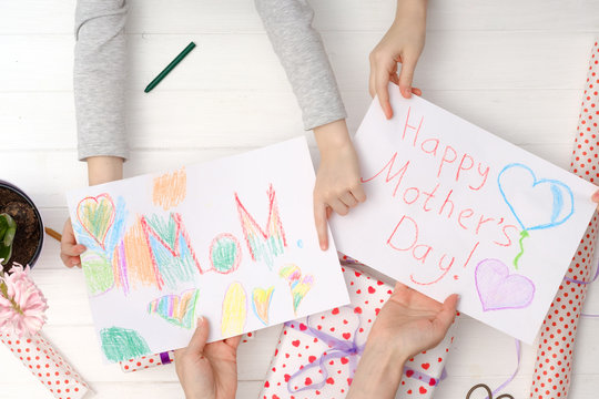 Little girls drawing a greatings cards for mothers day. Thanks to mother concept.