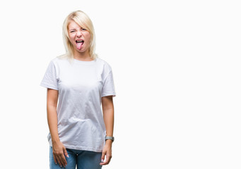 Fototapeta premium Young beautiful blonde woman wearing white t-shirt over isolated background sticking tongue out happy with funny expression. Emotion concept.