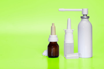 Three types of nasal sprays on a neon green background. Medical treatment for allergies and the common cold