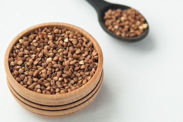 buckwheat seeds in bowl isolated on white