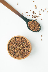 buckwheat in wooden spoon and bowle