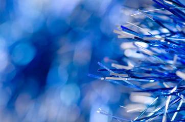 Blue tinsel Christmas new year sparkles macro blur background