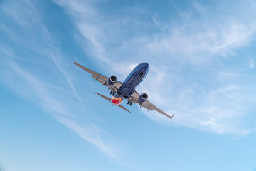 Fototapeta na wymiar Aviation, travel, air transportation concept. Airplane in blue sky