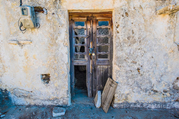 Wood broken door in old stone house