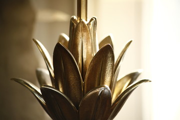 Detail of a golden, floral, antique light