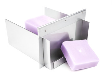 Stainless steel soap cutting tool with handmade soap loaf inside on the white background