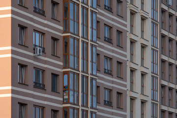 Facade of big modern building with apartments. Mortgage, accomodation, real estate construction concept