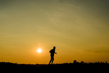 silhouette of old man runnig on sunset