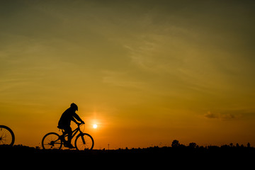 Fototapeta na wymiar silhouette of cyclist at sunset