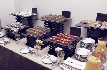 Assortment of snacks on banquet table, toned