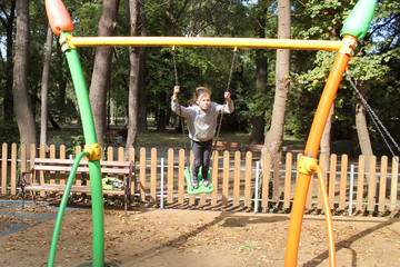 girl riding on a swing in the park
