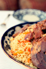Traditional pilaf on restaurant table, toned image