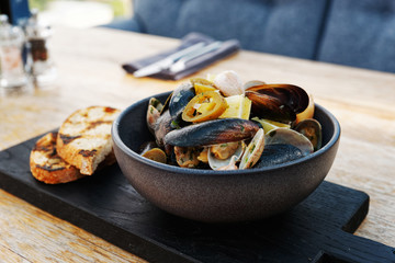 Clams and mussels stew with grilled bread, toned