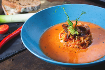 French fish soup Bouillabaisse with seafood, salmon fillet, shrimp, rich flavor