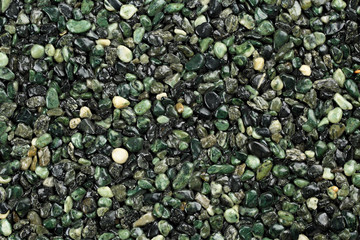 Close up of dark green colored natural stone carpet. Decorative stone coating. Slip resistant floor...