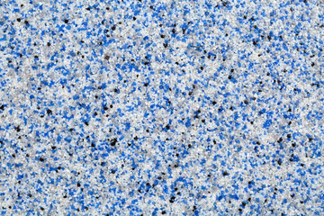 Close up of decorative quartz sand epoxy floor or wall coating with blue, grey, white and black...