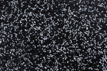Close up of decorative quartz sand epoxy coated floor or wall coating with grey and black coloured...