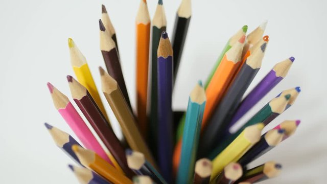 Pencil on a white background. Camera in motion. Pencils are in the glass