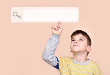 Young boy touching search button on a virtual touch screen