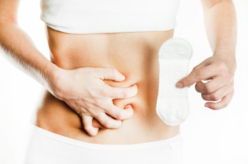 Women Period Product. Closeup Of Beautiful Fit Slim Female Body In White Underwear Holding Sanitary Napkin, Towel In Hand. Woman Holding Clean Period Pad. Feminine Intimate Hygiene. High Resolution