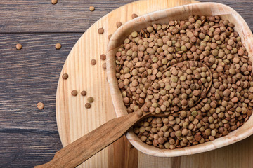 A wooden spoon full of canadian green large lentils