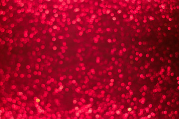Holiday shiny red bokeh background, glitter, sparkles, defocused glow