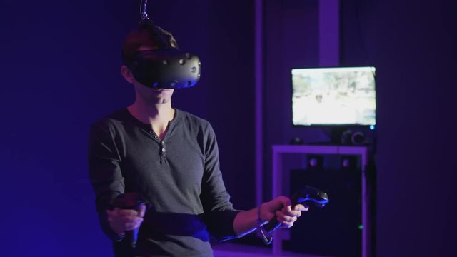 Man plays VR video game in vr club