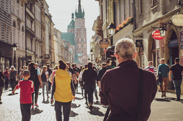 13.07.2018 Krakow, Poland: tourist travel photographer taking photo of the street with dslr camera,...